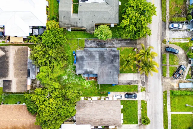an aerial view of a house with a yard and garden