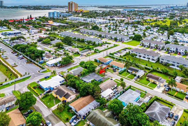 an aerial view of residential houses with outdoor space and swimming pool