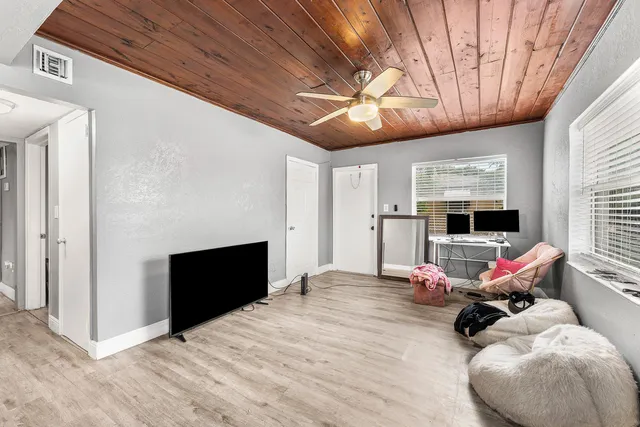 a room with furniture and flat screen tv