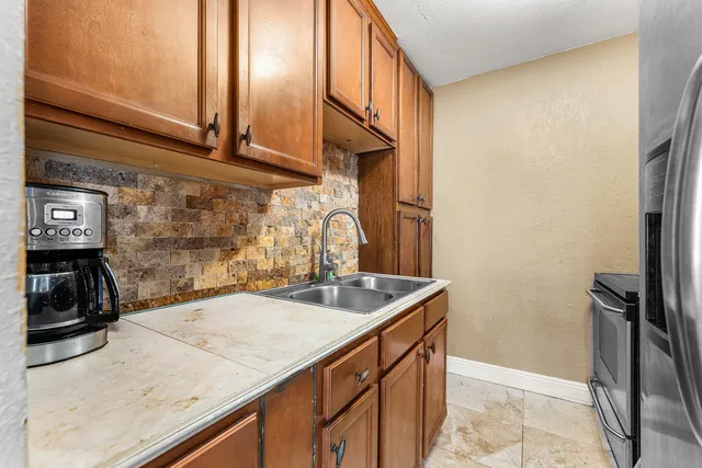 a kitchen with a sink and a refrigerator