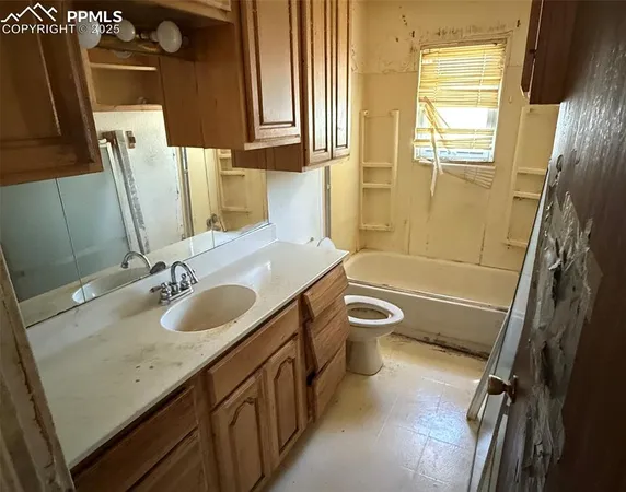 a bathroom with a sink a toilet and tub