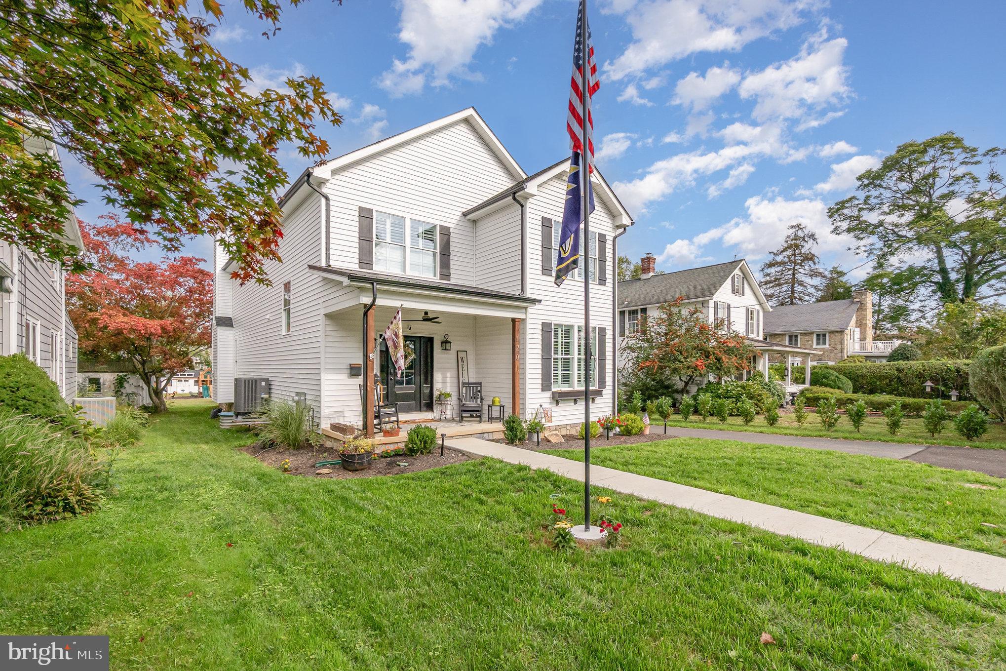 a front view of a house with a yard table and chairs