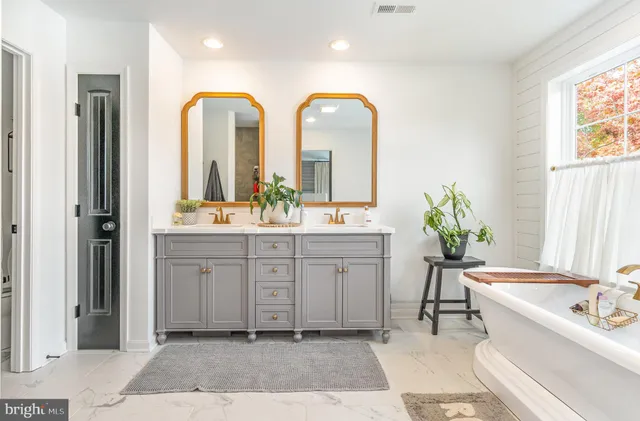 a spacious bedroom with a bed and glass windows