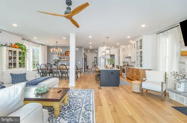 a living room with furniture and kitchen view