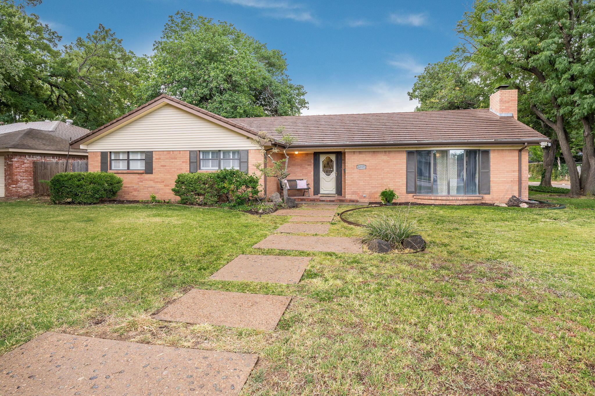 6019 Calumet Road Amarillo, TX 79106 - Photo 1 of 25 a front view of a house with yard