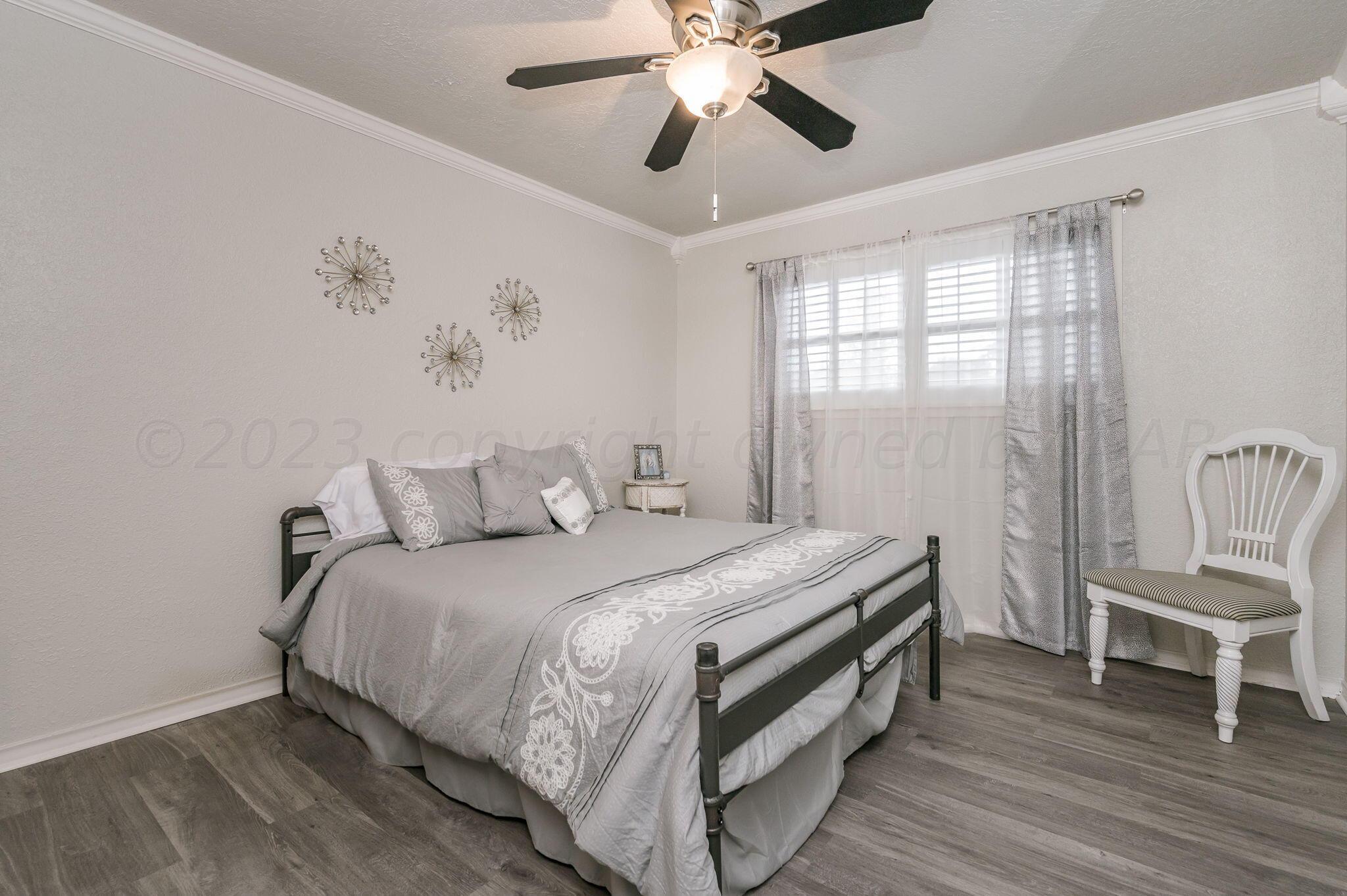6019 Calumet Road Amarillo, TX 79106 - Photo 16 of 25 a bed room with a bed and a chair