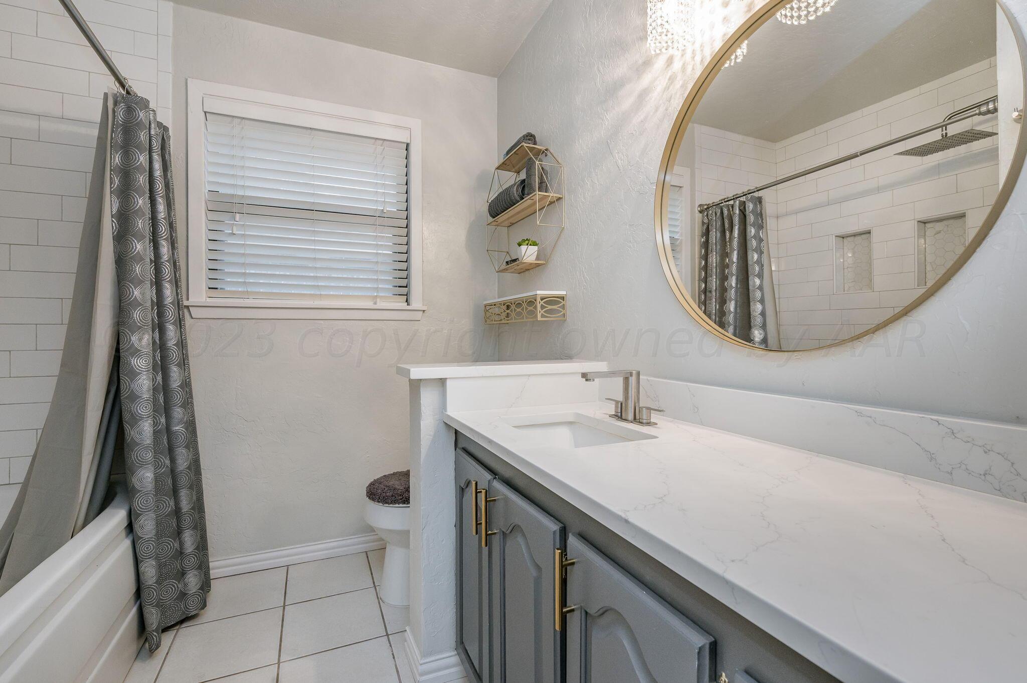 6019 Calumet Road Amarillo, TX 79106 - Photo 17 of 25 a bathroom with a sink and a mirror