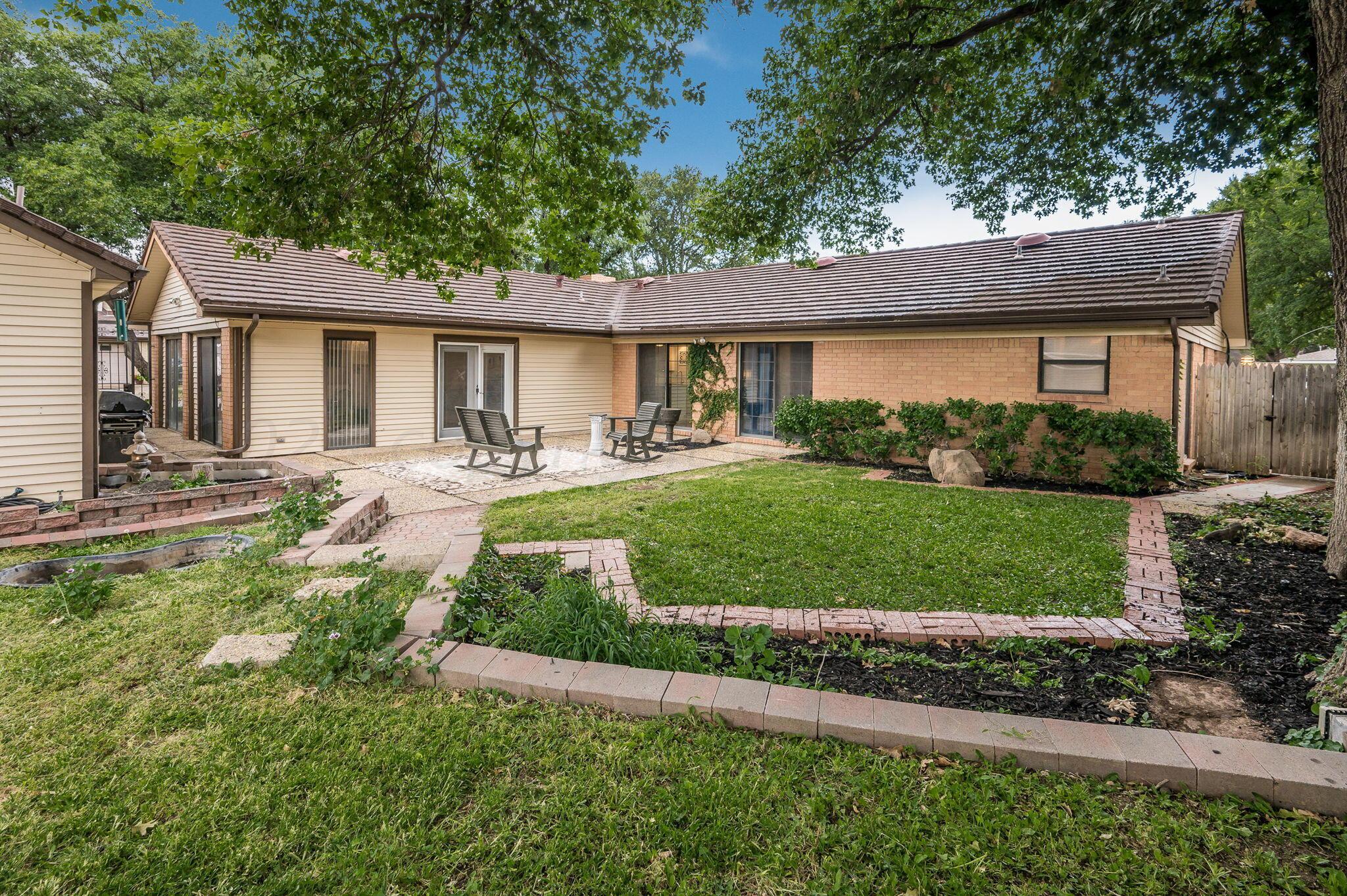 6019 Calumet Road Amarillo, TX 79106 - Photo 24 of 25 a front view of a house with a yard and potted plants