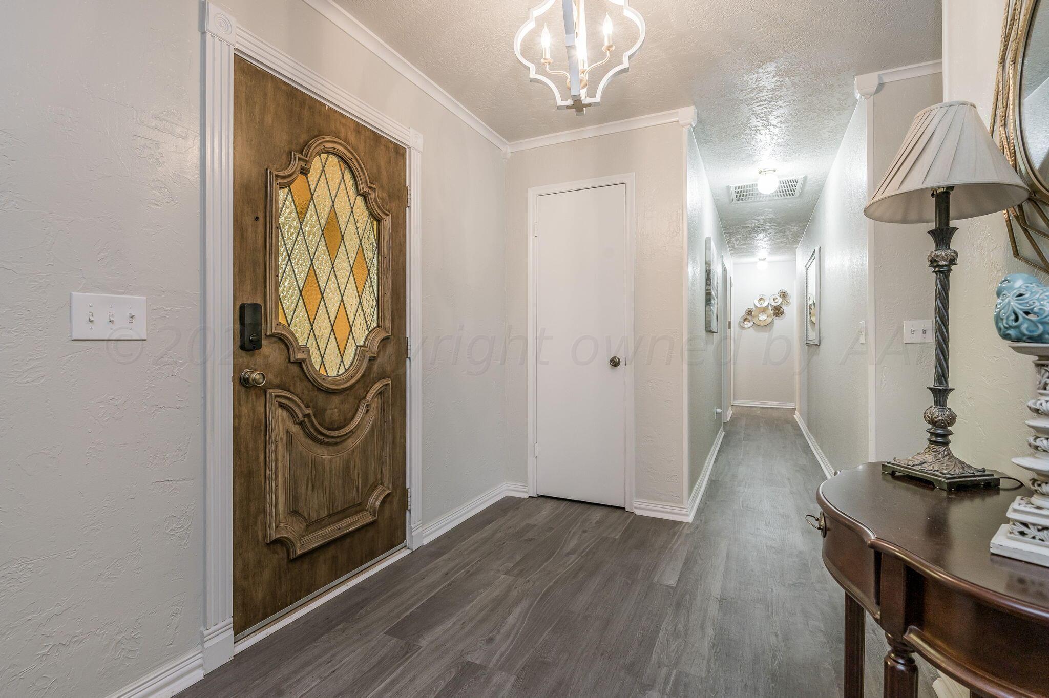 6019 Calumet Road Amarillo, TX 79106 - Photo 3 of 25 a view of a hallway with wooden floor and staircase