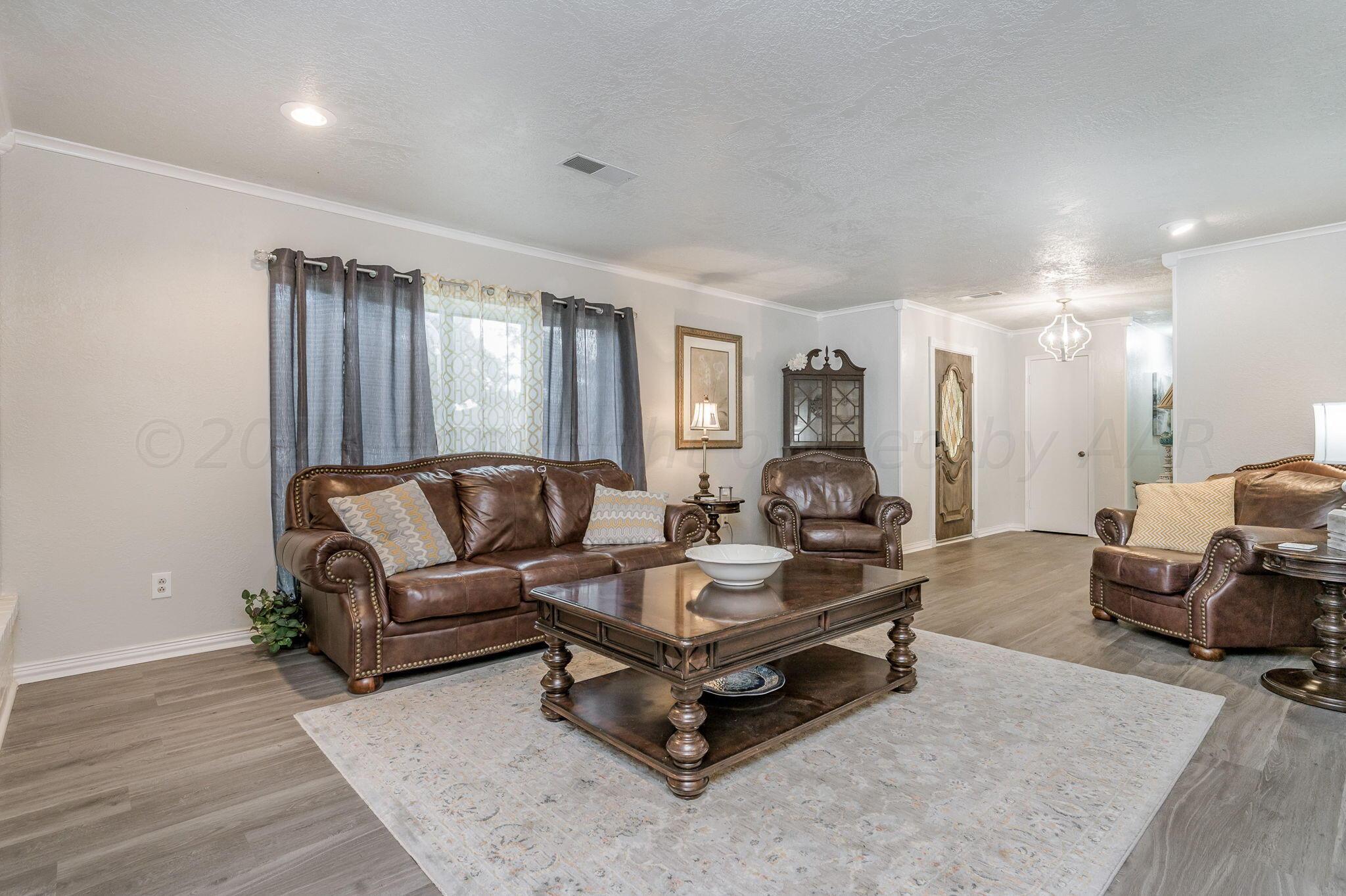 6019 Calumet Road Amarillo, TX 79106 - Photo 5 of 25 a living room with furniture and wooden floor