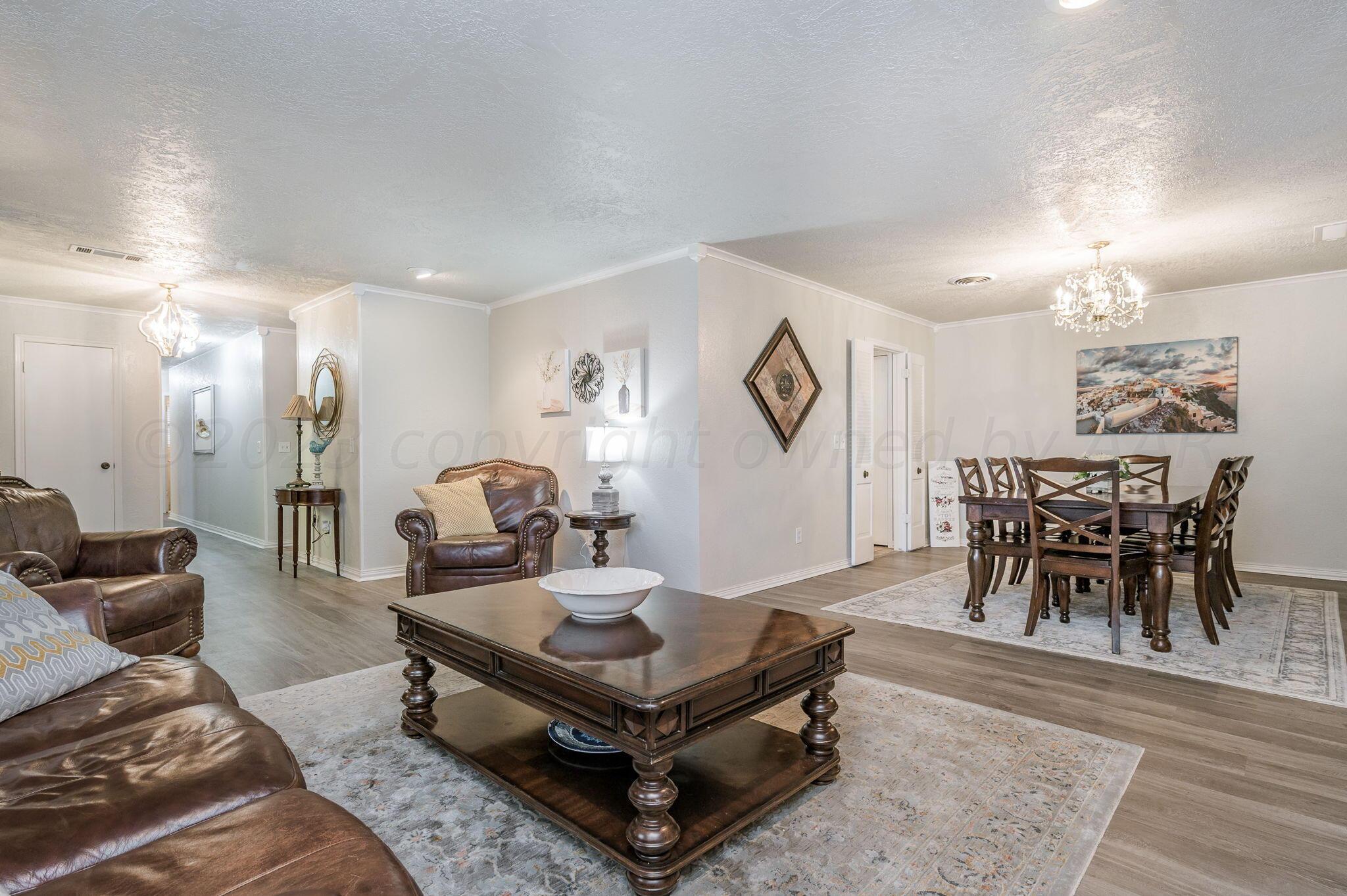 6019 Calumet Road Amarillo, TX 79106 - Photo 6 of 25 a living room with furniture and a chandelier