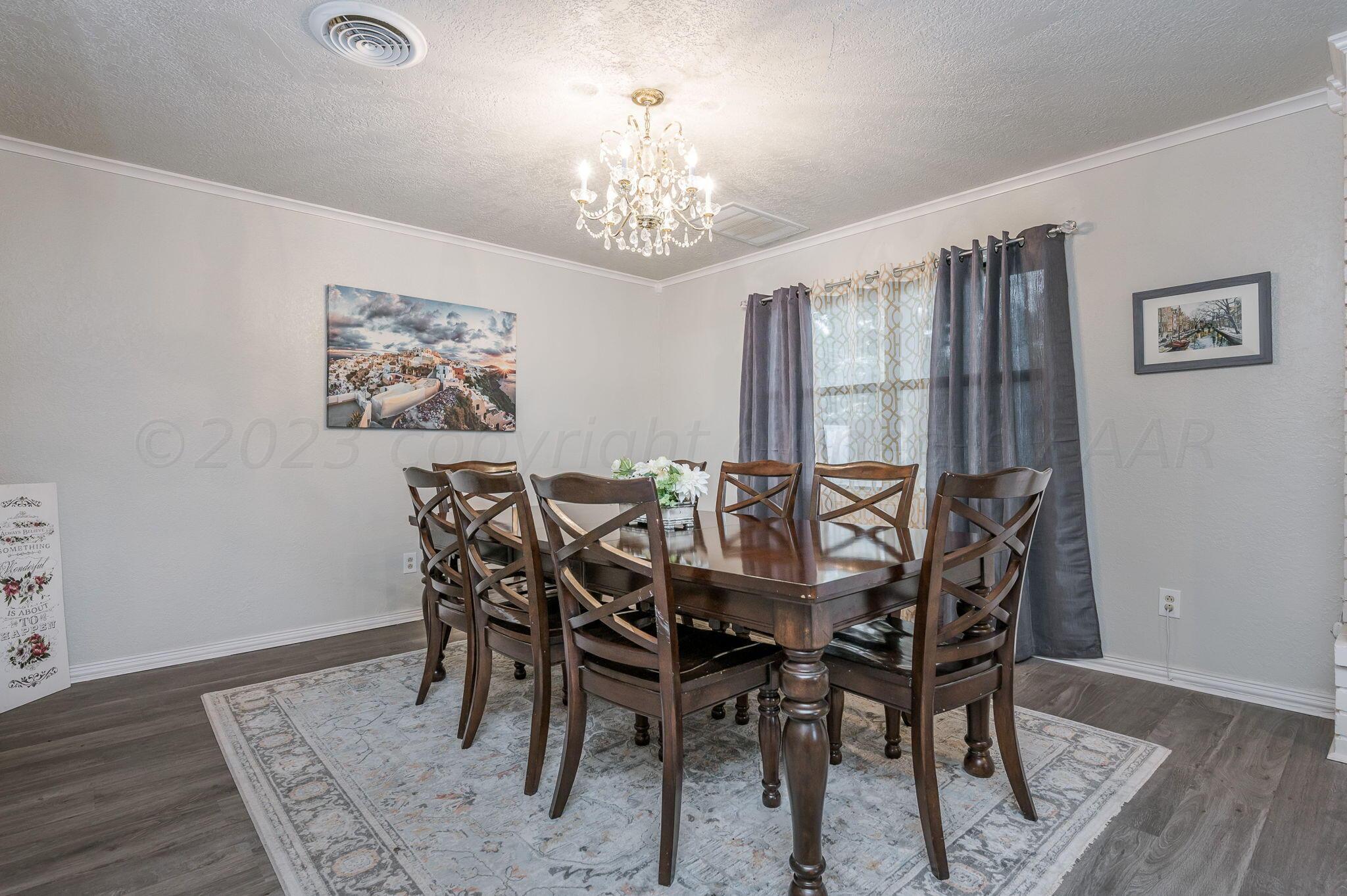 6019 Calumet Road Amarillo, TX 79106 - Photo 7 of 25 a view of a dining room with furniture window and wooden floor