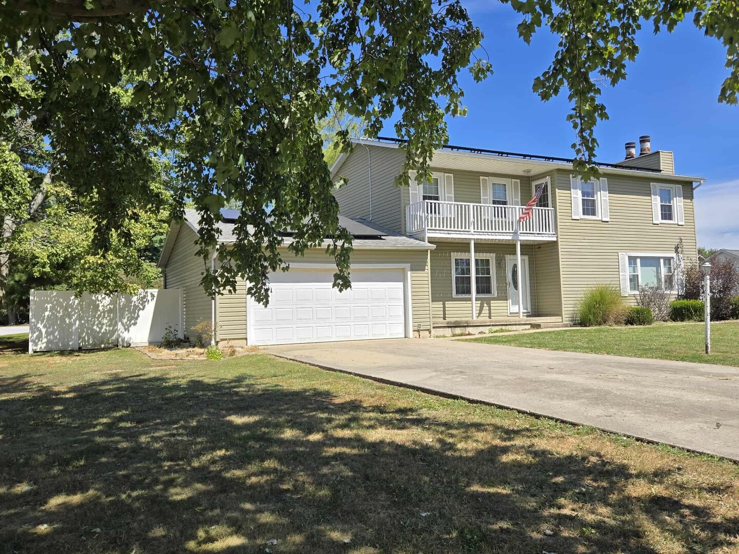 a front view of a house with a garden and yard