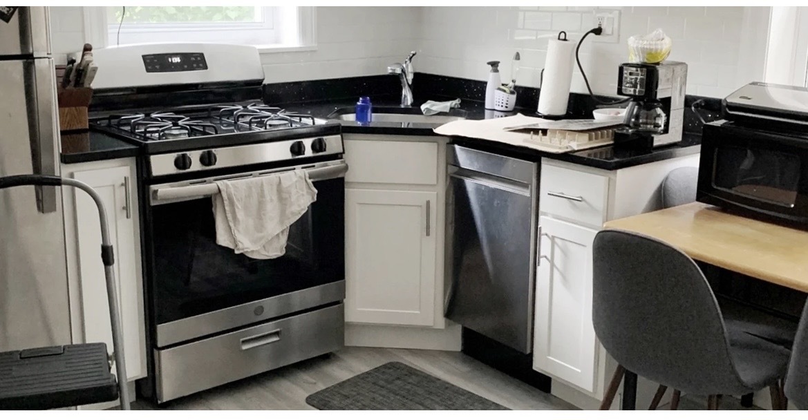 646 West Roscoe Street, Unit 1N Chicago, IL 60657 - Photo 8 of 11 a kitchen with stainless steel appliances granite countertop a stove and a refrigerator
