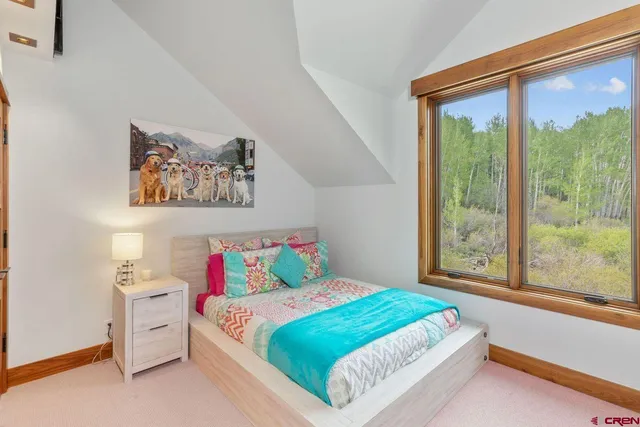 a bedroom with a bed and a large window