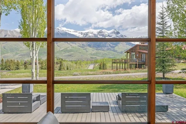 a view of a garden with couches in a patio