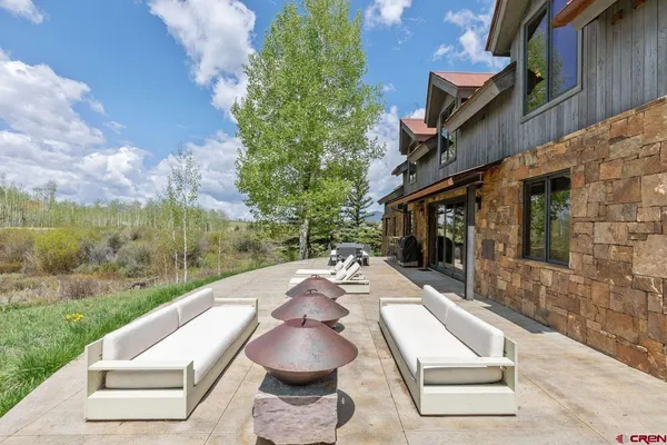 a view of a backyard with table and chairs with wooden fence