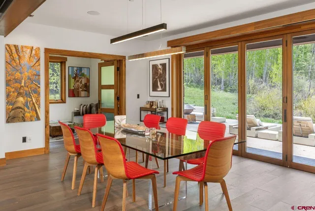 a dining room with furniture and large windows
