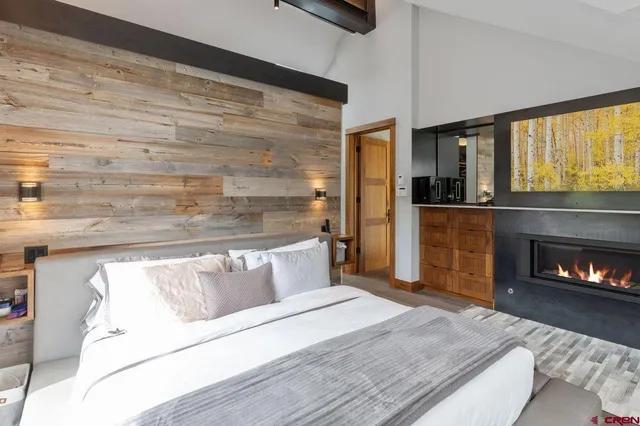 a bedroom with a bed and a fireplace