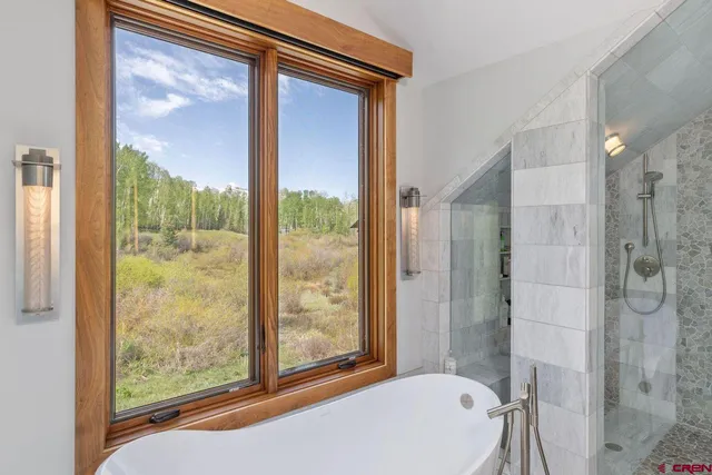 a bathroom with a bathtub and shower