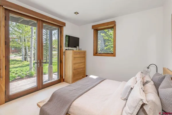 a bedroom with a bed and glass window