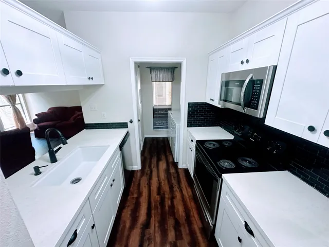 a kitchen with a sink a stove and refrigerator