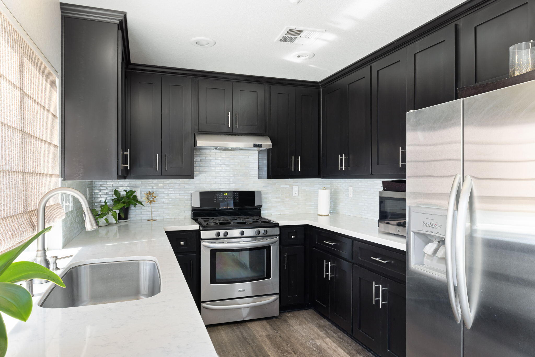 7607 Canberra Way Riverside, CA 92508 - Photo 14 of 28 a kitchen with kitchen island stainless steel appliances a stove a sink and a refrigerator