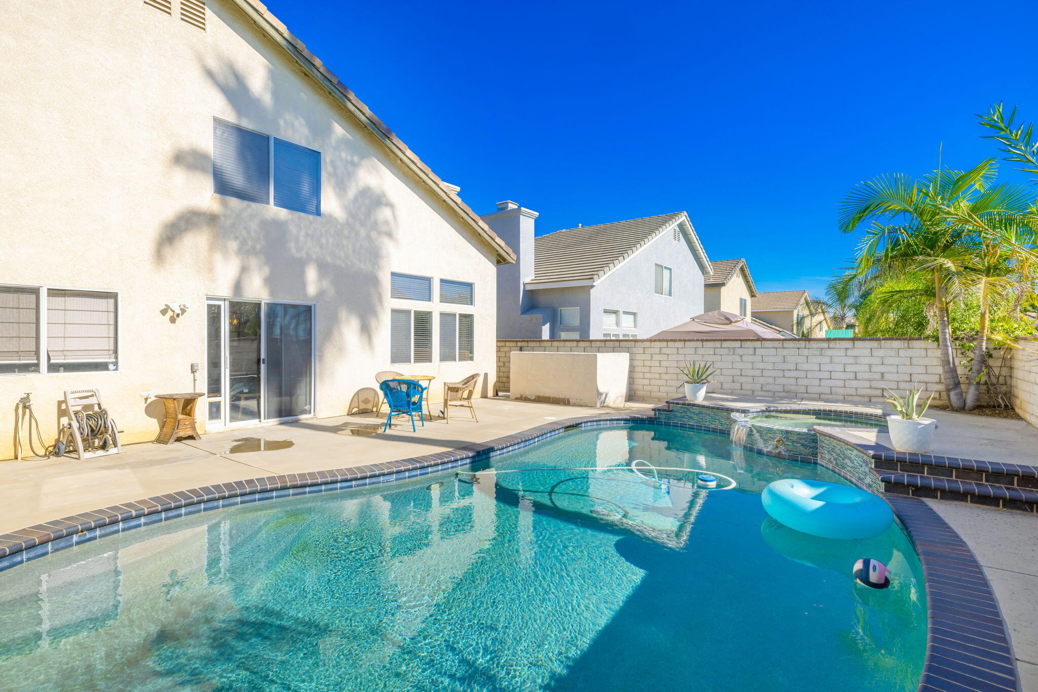 7607 Canberra Way Riverside, CA 92508 - Photo 17 of 28 a view of a house with pool and chairs