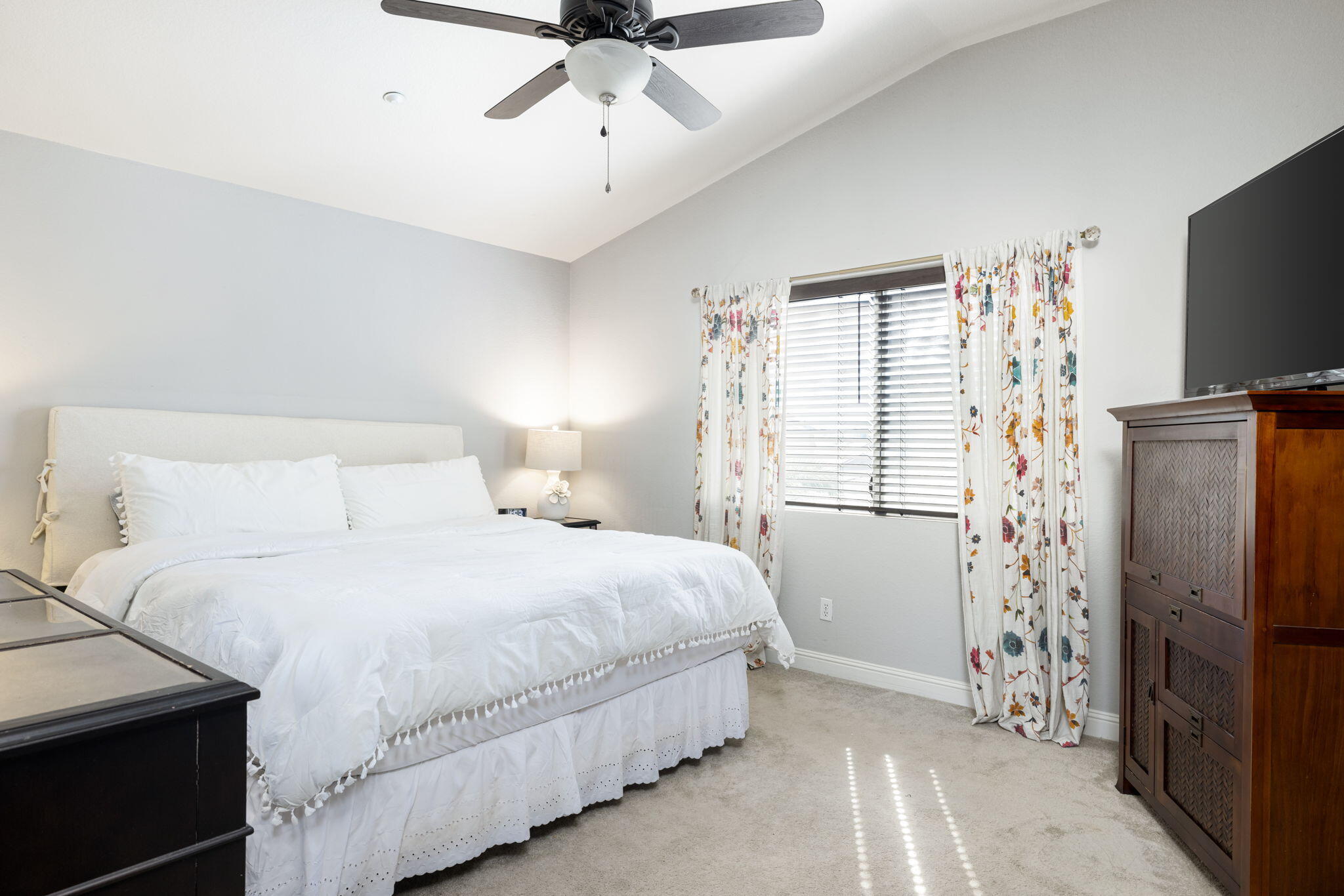 7607 Canberra Way Riverside, CA 92508 - Photo 21 of 28 a bedroom with a bed and a flat tv screen on dresser