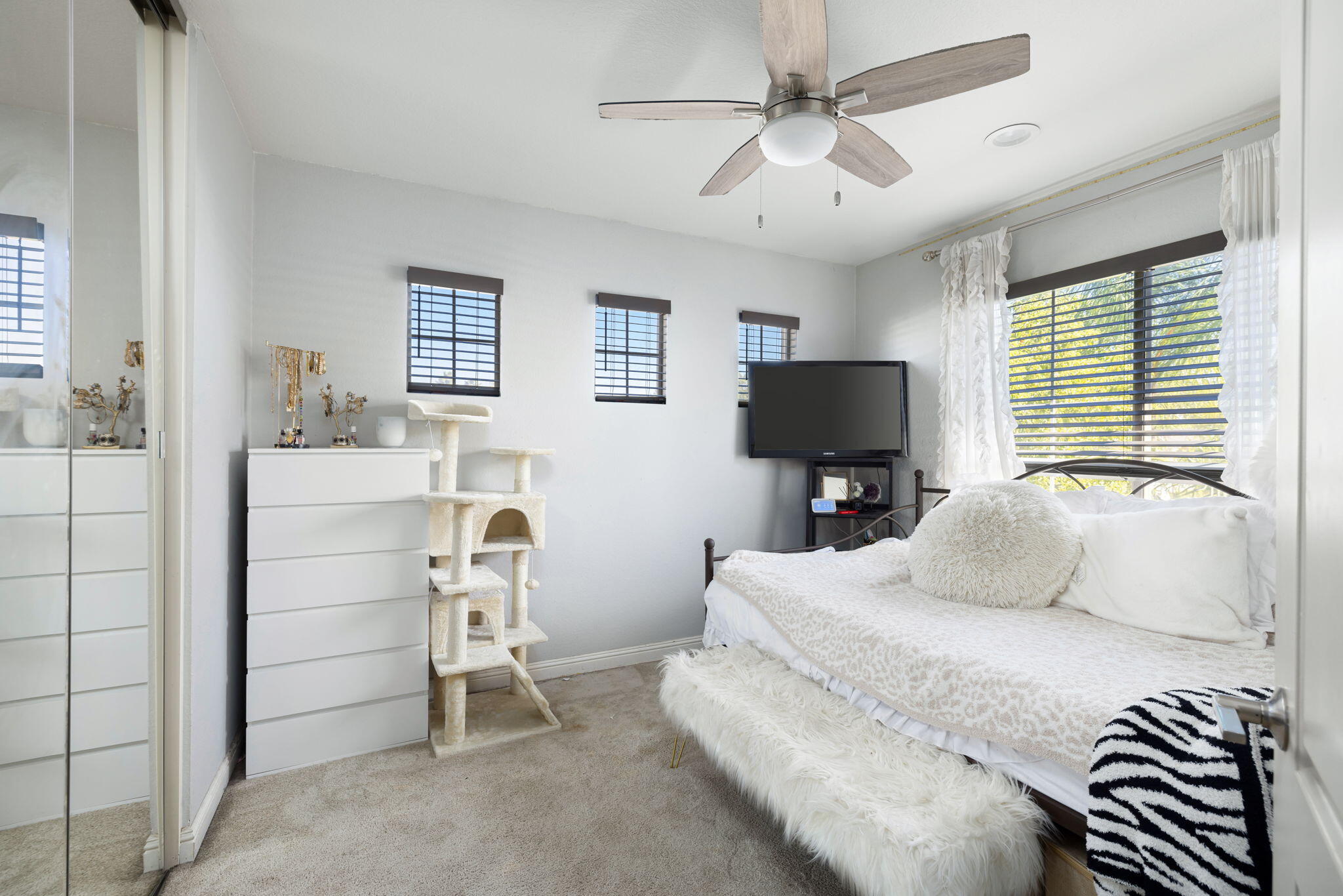 7607 Canberra Way Riverside, CA 92508 - Photo 24 of 28 a bedroom with a bed and a flat screen tv