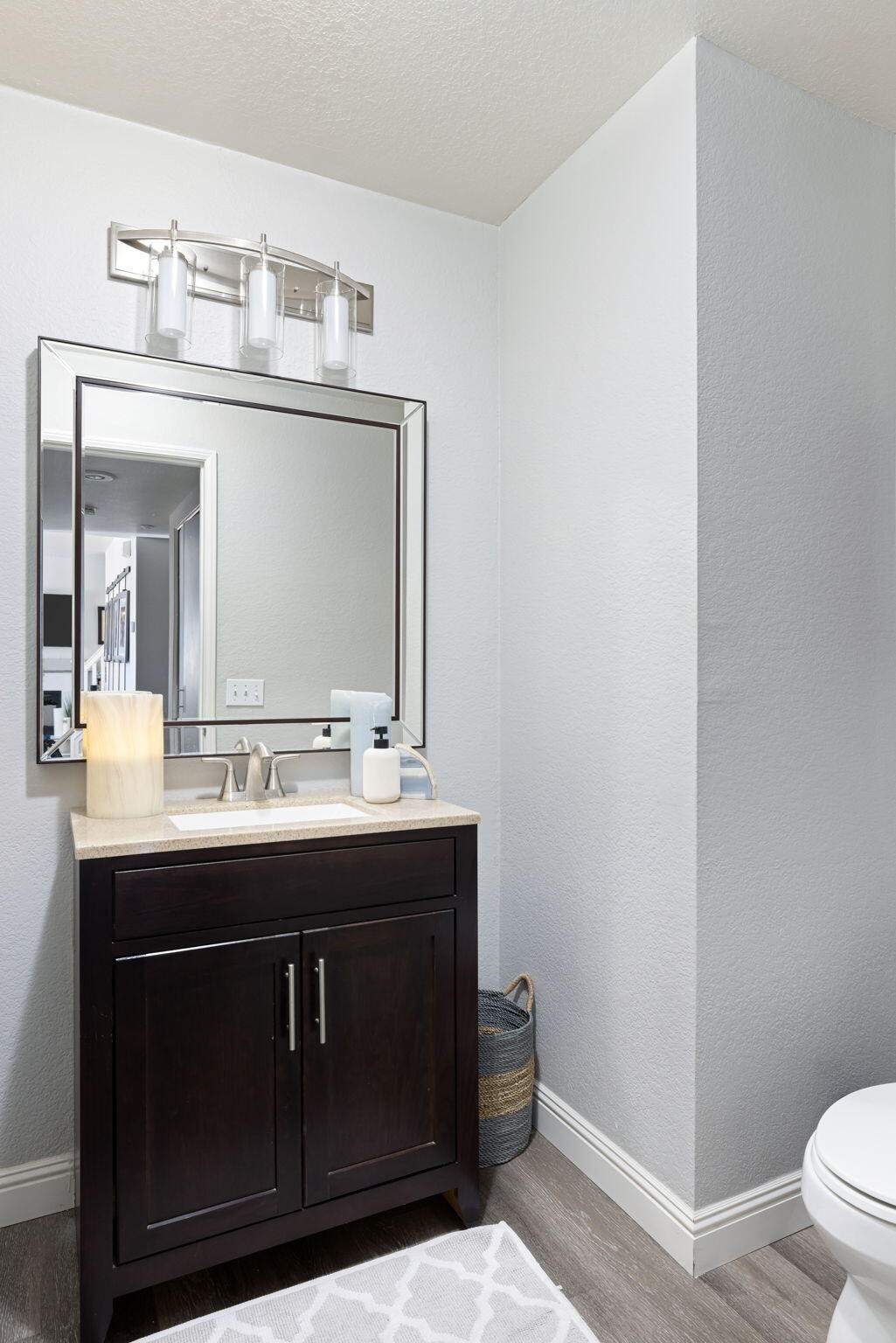 7607 Canberra Way Riverside, CA 92508 - Photo 28 of 28 a bathroom with a sink vanity and a toilet