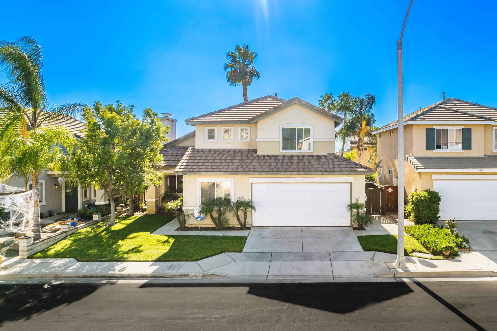 7607 Canberra Way Riverside, CA 92508 - Photo 4 of 28 a front view of a house with a yard