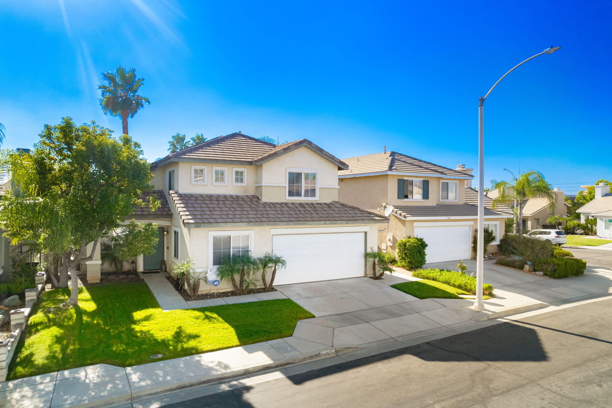 7607 Canberra Way Riverside, CA 92508 - Photo 5 of 28 a front view of a house with swimming pool garden and patio