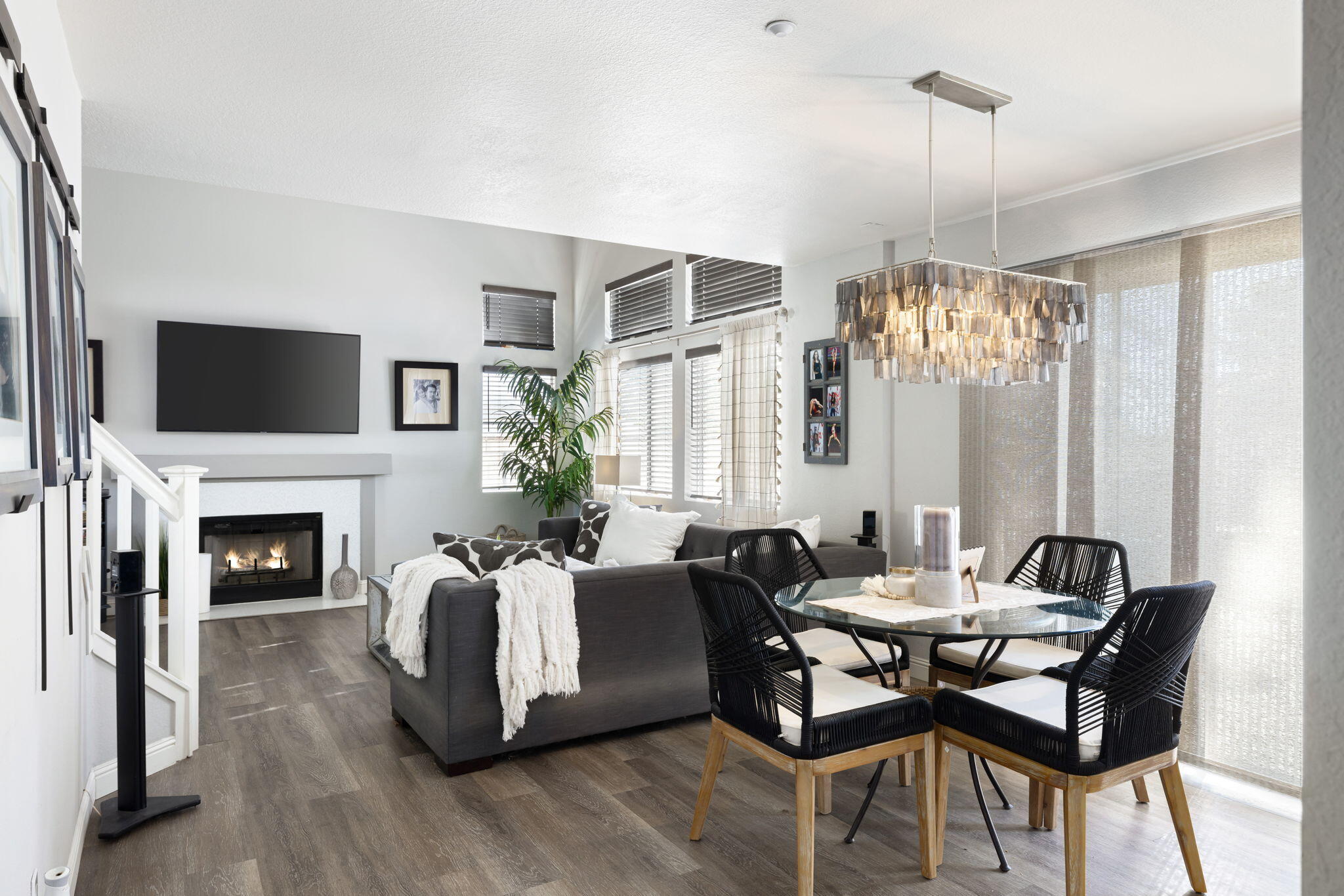 7607 Canberra Way Riverside, CA 92508 - Photo 9 of 28 a living room with furniture a fireplace and a chandelier