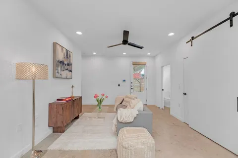 a living room with furniture and a lamp