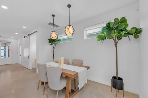 a very nice looking dining room with a table and chairs