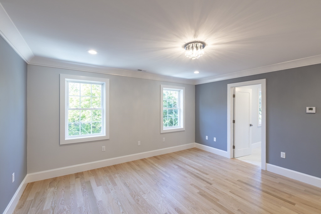 239 Hardy Pond Road Waltham, MA 02451 - Photo 12 of 28 an empty room with wooden floor and windows