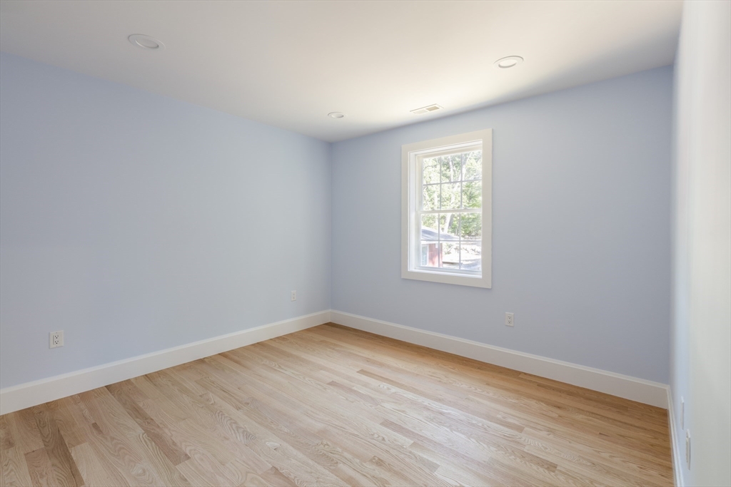 239 Hardy Pond Road Waltham, MA 02451 - Photo 20 of 28 wooden floor in an empty room with a window