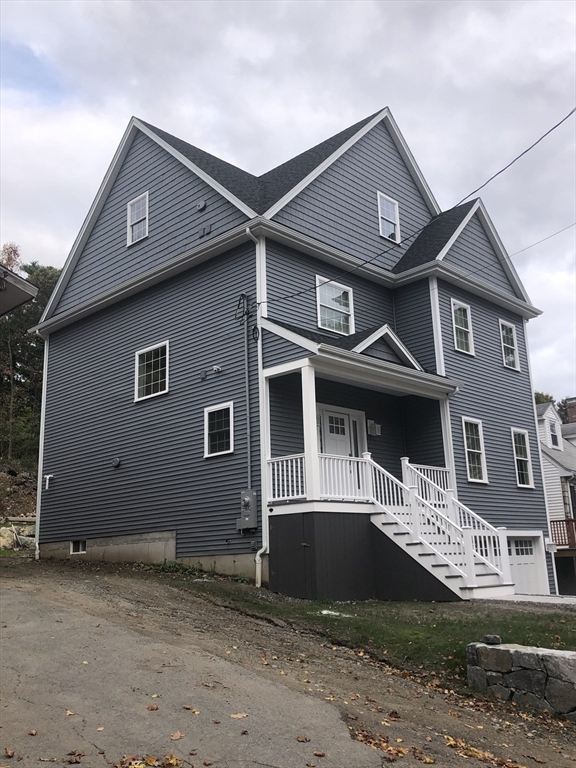 239 Hardy Pond Road Waltham, MA 02451 - Photo 2 of 28 a front view of a house with a yard