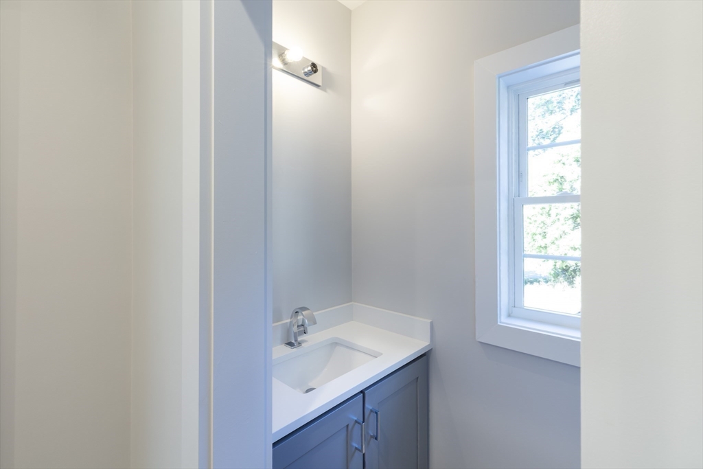 239 Hardy Pond Road Waltham, MA 02451 - Photo 24 of 28 a bathroom with a sink and mirror with window