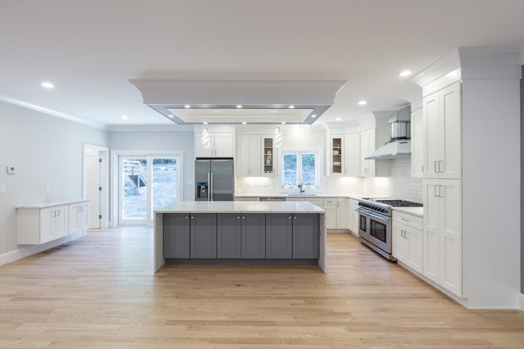 239 Hardy Pond Road Waltham, MA 02451 - Photo 3 of 28 a large kitchen with stainless steel appliances lots of counter space and a sink
