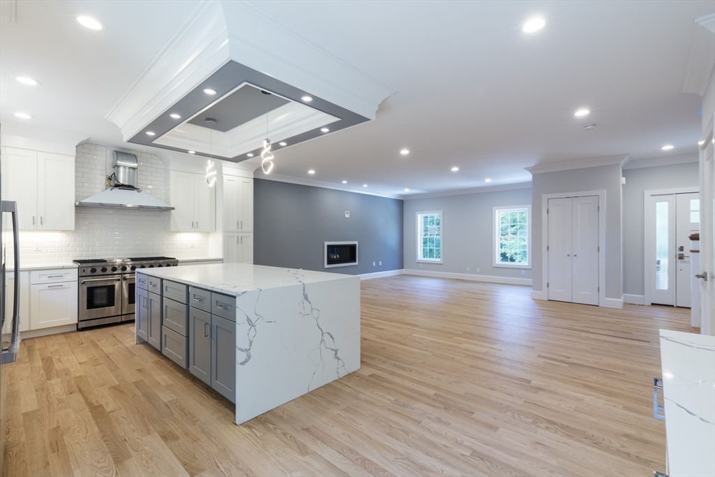 239 Hardy Pond Road Waltham, MA 02451 - Photo 4 of 28 a large kitchen with stainless steel appliances granite countertop a stove and a refrigerator