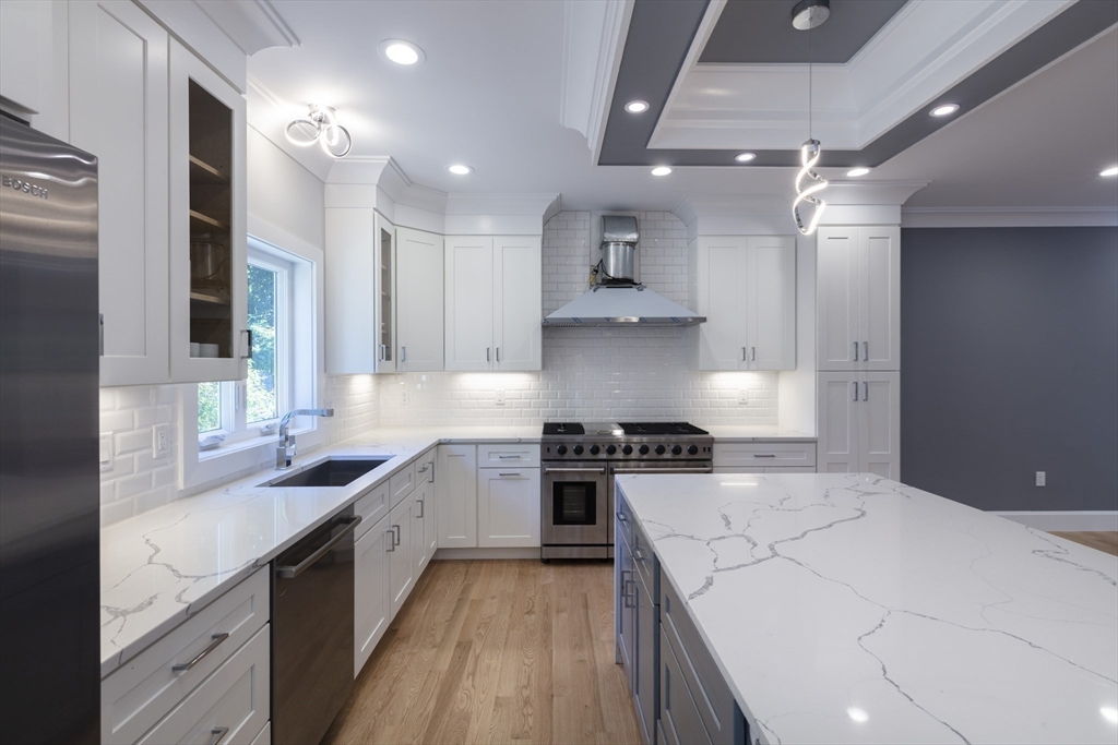 239 Hardy Pond Road Waltham, MA 02451 - Photo 5 of 28 a open kitchen with stainless steel appliances granite countertop a sink stove and refrigerator