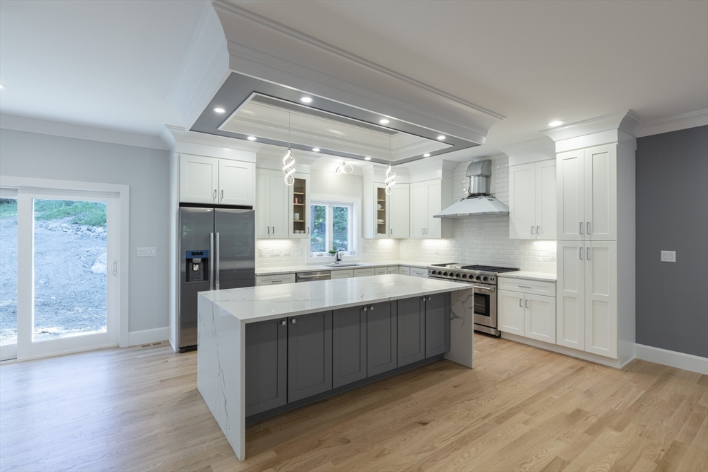 239 Hardy Pond Road Waltham, MA 02451 - Photo 6 of 28 a kitchen with stainless steel appliances granite countertop a sink stove and refrigerator