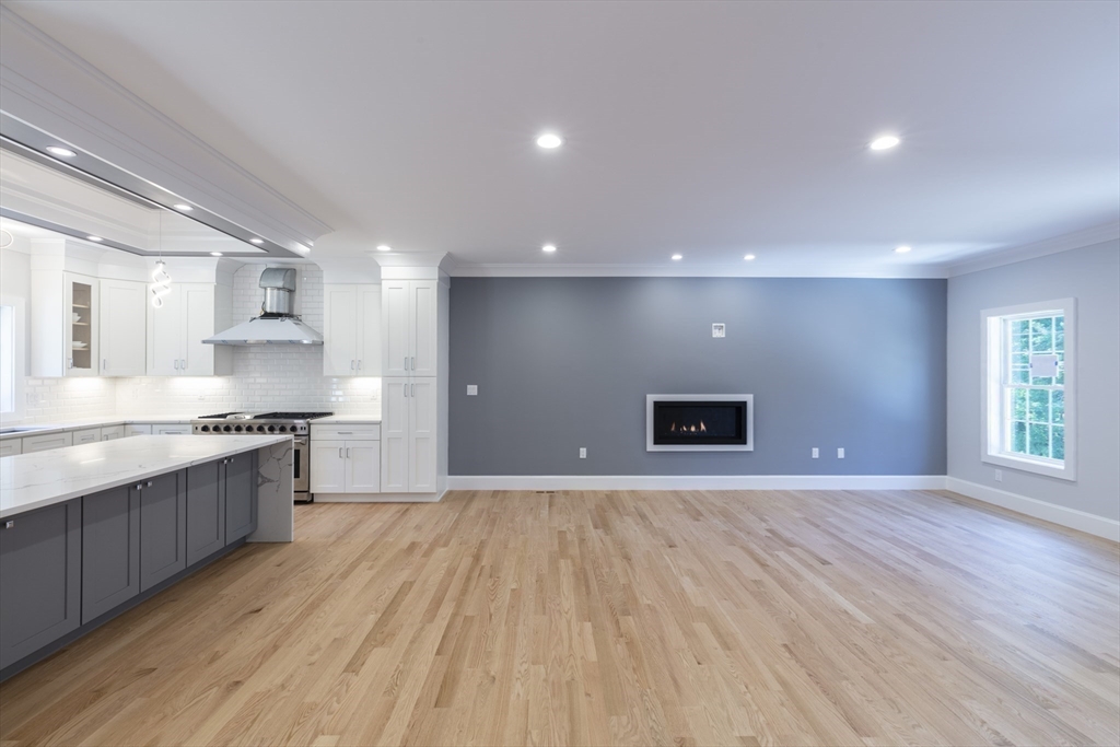 239 Hardy Pond Road Waltham, MA 02451 - Photo 9 of 28 a view of an empty room with window and wooden floor