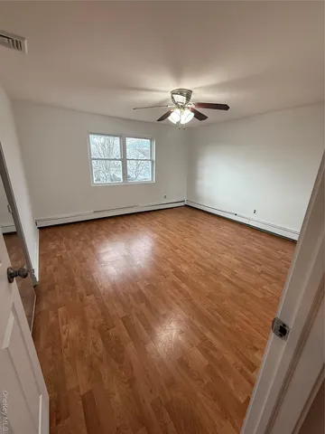 wooden floor in an empty room with a window