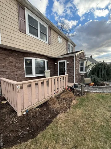 a view of a house with backyard and sitting area
