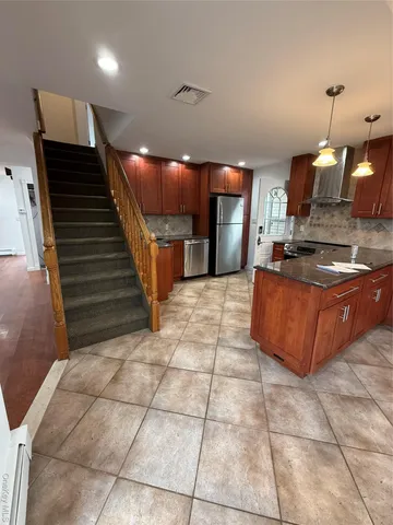 a kitchen with stainless steel appliances a sink a counter top space cabinets and a view of kitchen