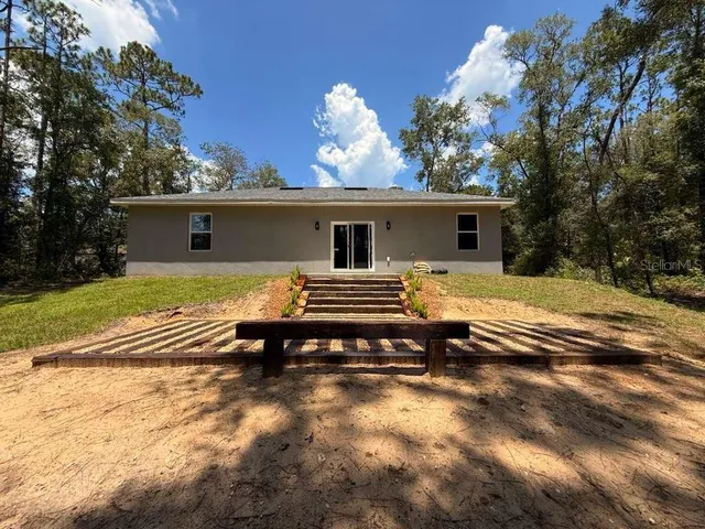 a view of a house with a wooden fence