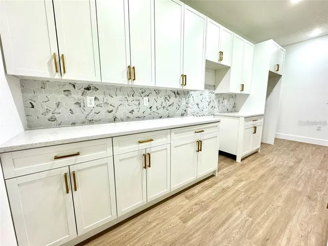 a view of cabinets with wooden floor